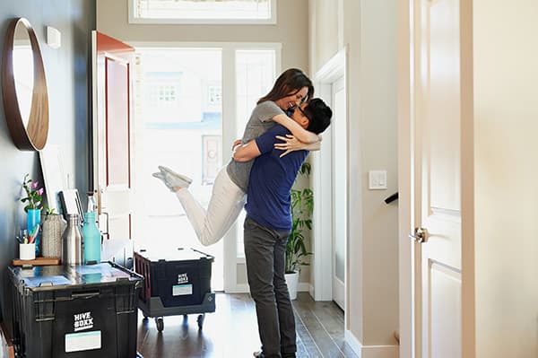 Couple hugging next to packed boxes